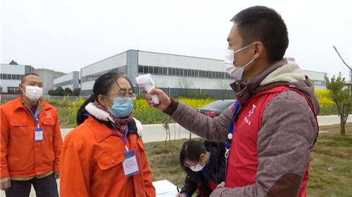 党员志愿者正在给工人测量体温.jpg