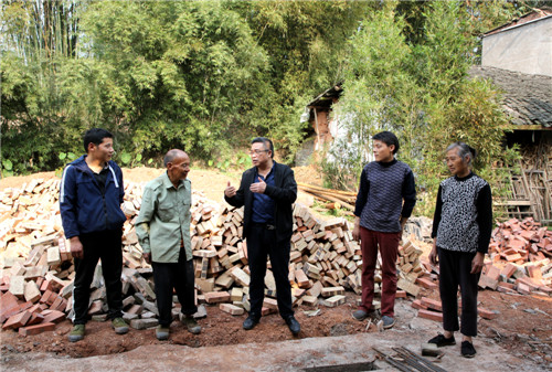 泸州市纳溪区农业农村局畜牧专家胡南到纳溪区龙车镇大堰村脱贫户杨学澄家里，指导他修建黑山羊养殖场 王超明摄.jpg